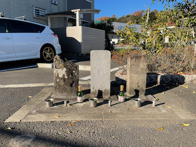 Three stones in front of an apartment building