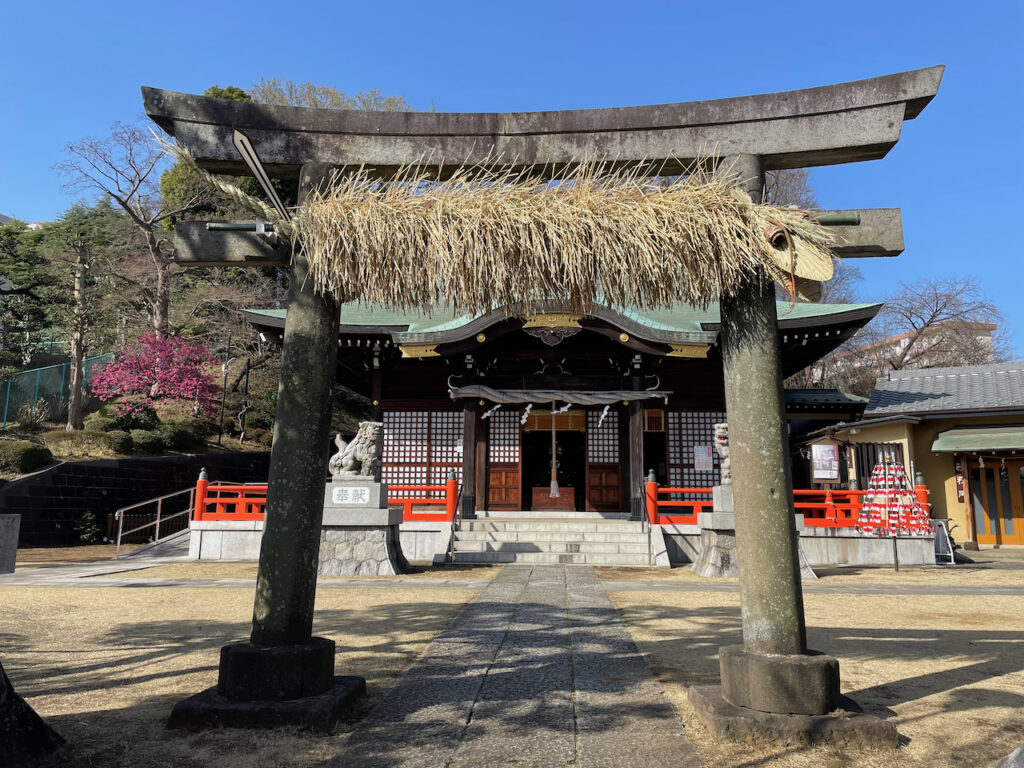 The whole torii, with the snake, and the prayer hall in the background